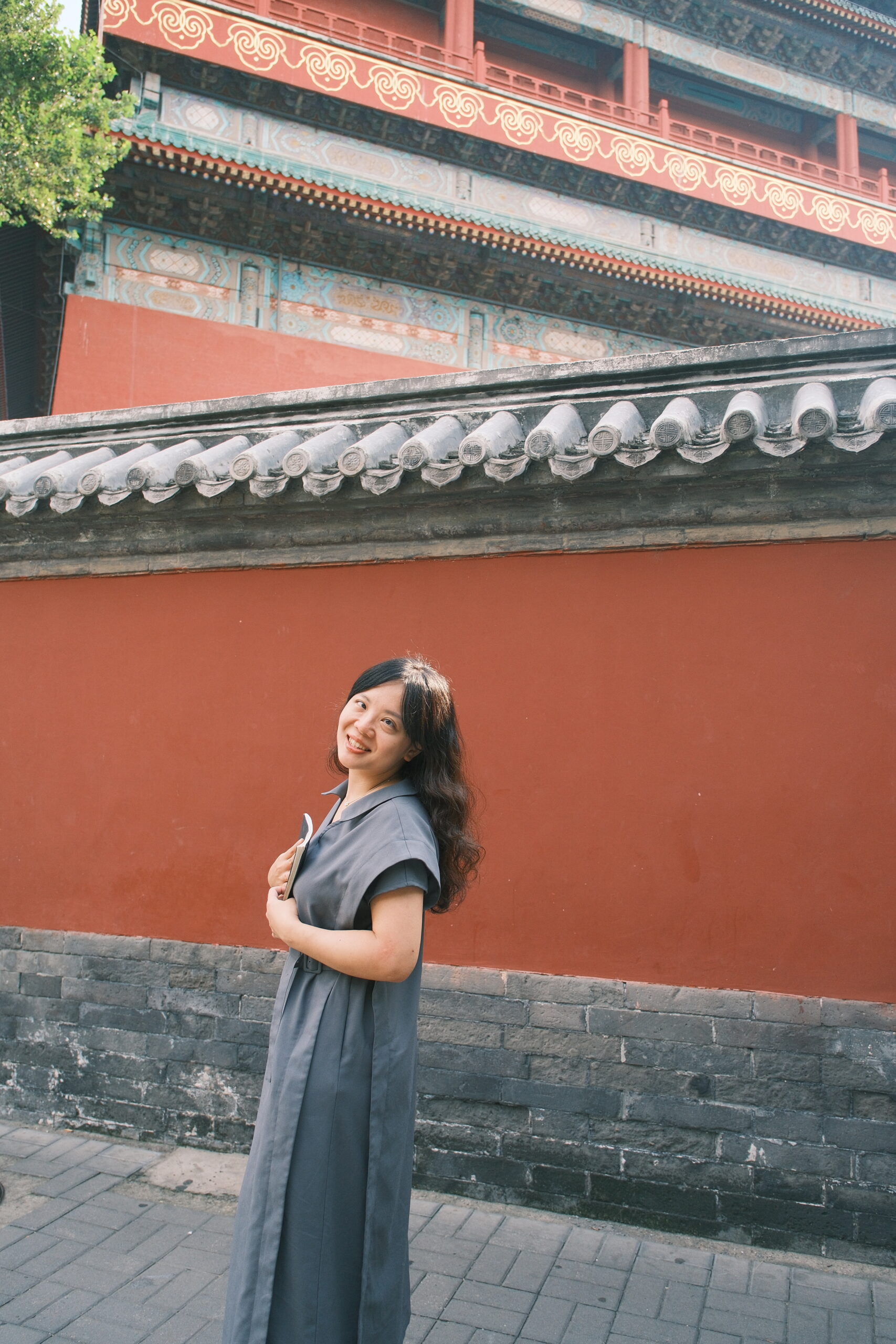 Wenrou smiling near a sunlit window in mindful contemplation